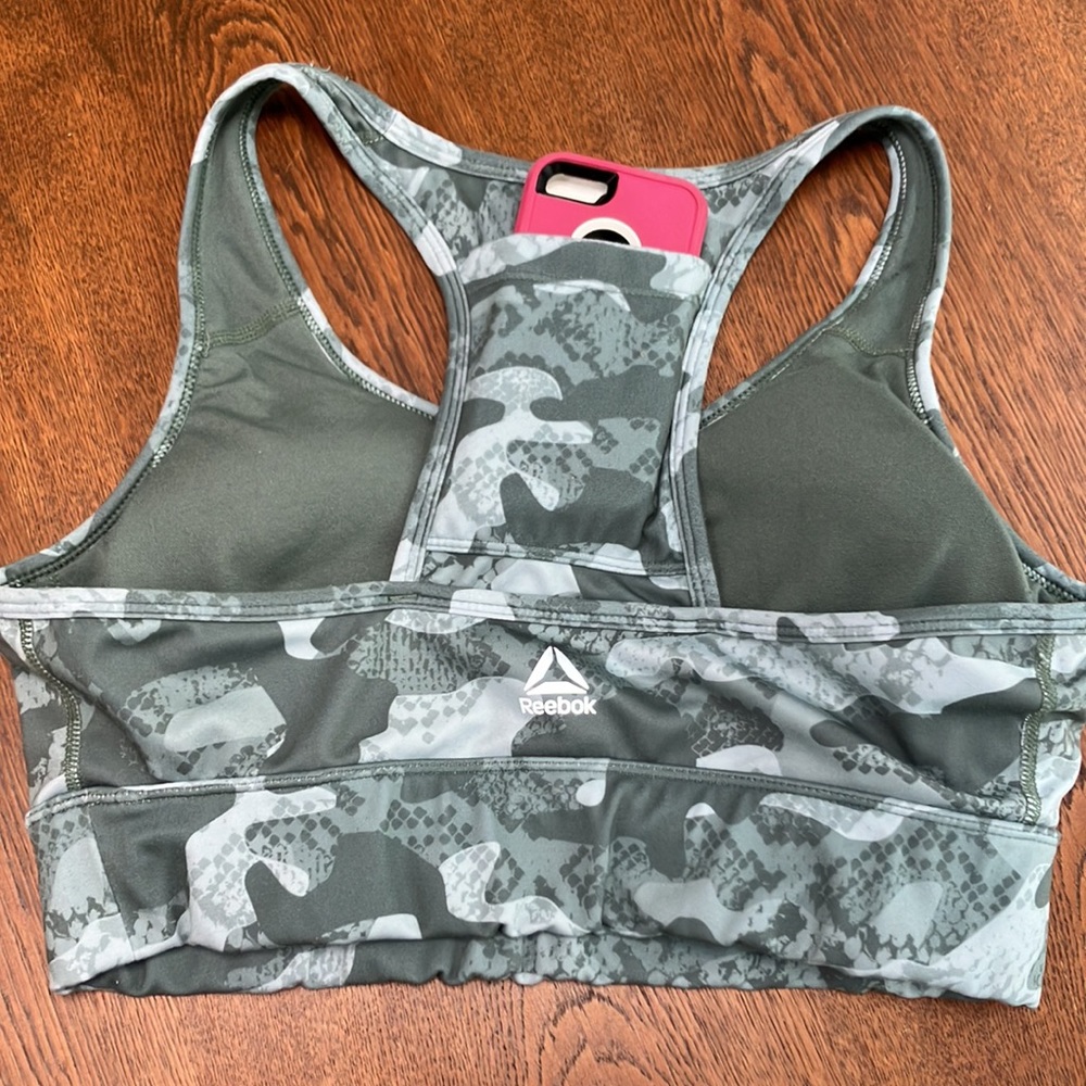 Multicolored green Reebok workout top WITH pocket for phone or license.